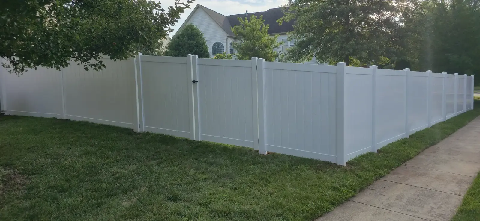 White vinyl privacy fence with three gates installed in Frederick County, Maryland